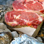 cooking steaks on campfire rocks